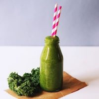 kale smoothie in glass milk bottle for recipe card.