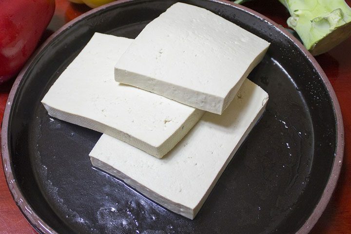 thin blocks of tofu in a plate as example of vegetarian protein source.