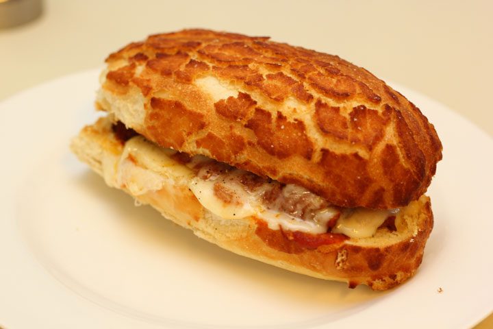 vegetarian meatball sub sandwich assembled in toasted dutch crunch roll.